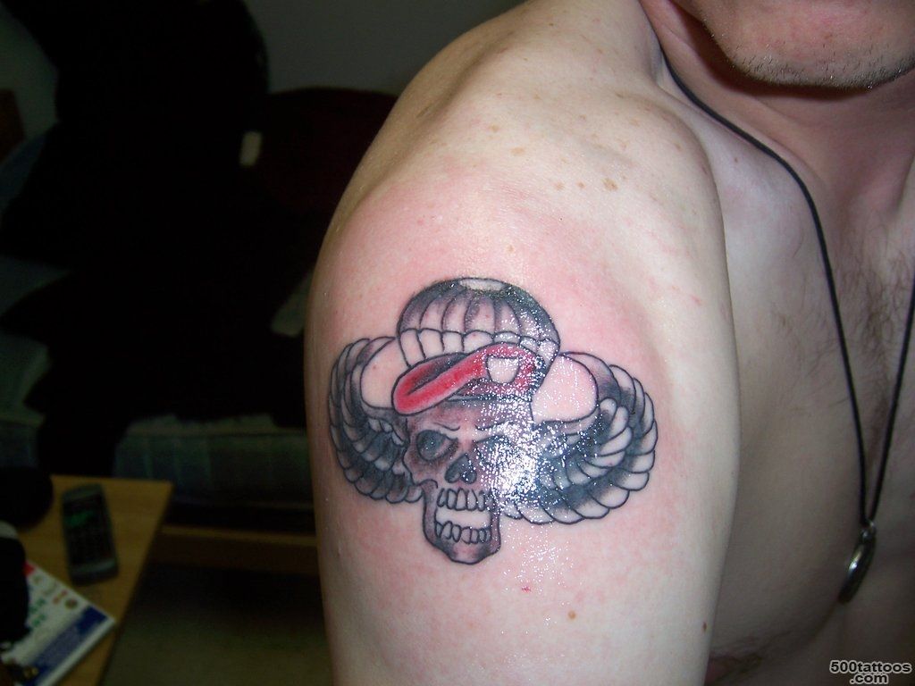 Crisp airborne tattoo in blackwork style on the upper arm