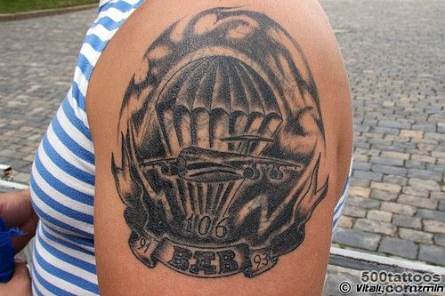 Black and grey airborne tattoo with delicate linework on the ribs