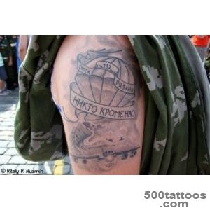 A tribal airborne tattoo on the chest with dynamic detail