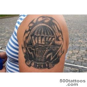 Black and grey airborne tattoo with delicate linework on the ribs