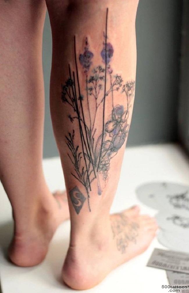 Black and grey leg tattoo with elegant linework on the spine