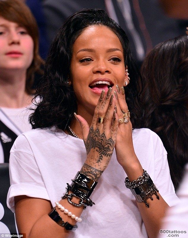 Rihanna admires the new tattoo on her right wrist after staying up ..._35