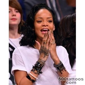 Rihanna admires the new tattoo on her right wrist after staying up _35